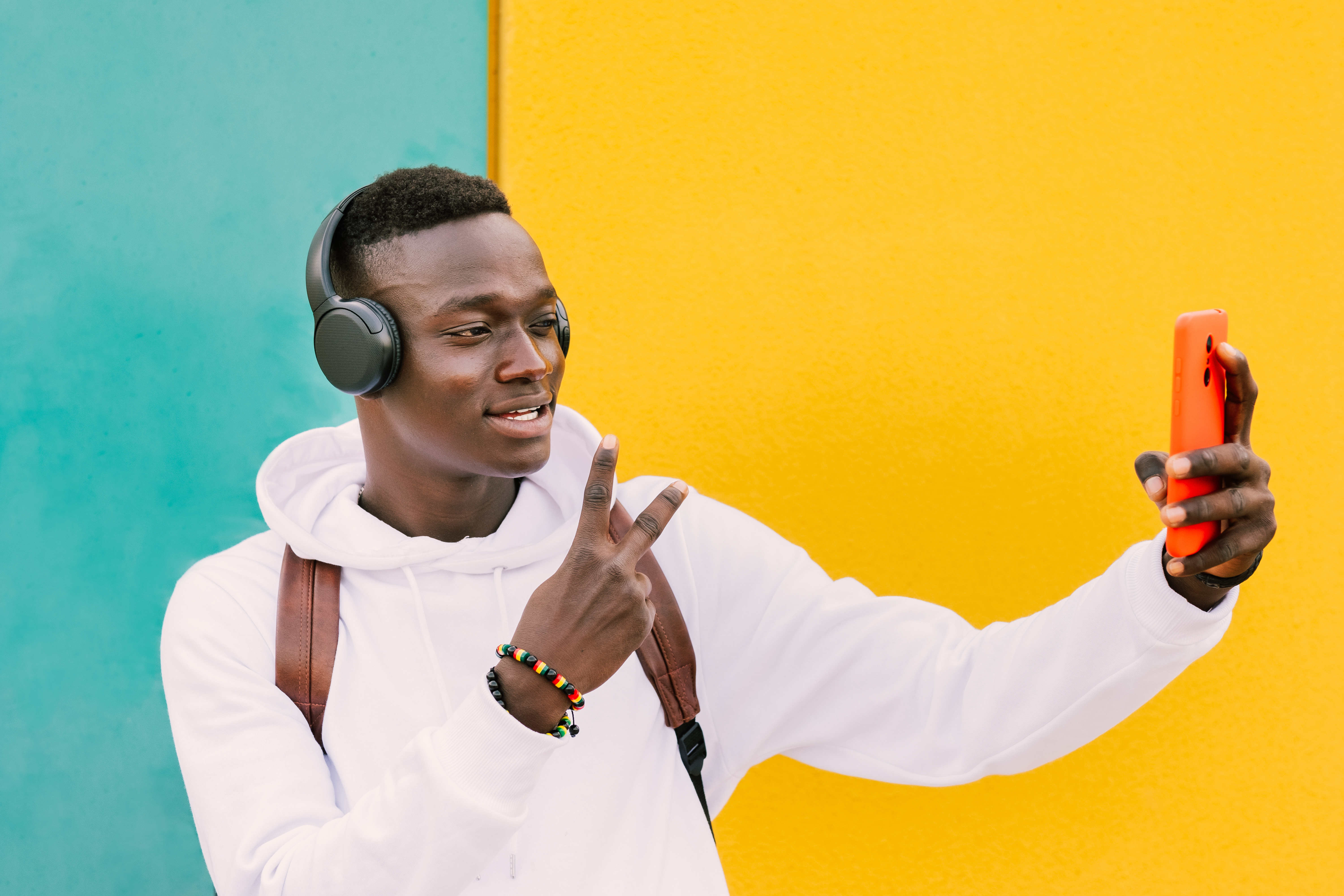 A young man looks at his phone