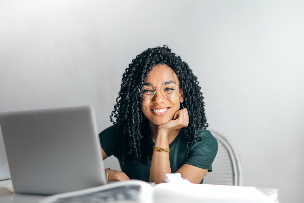 A young woman with dark hair looks confident like a young entrepreneur